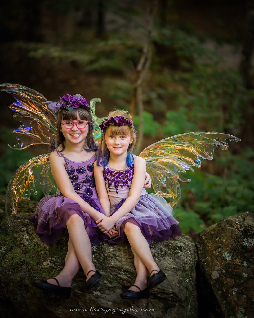 Two girls wearing purple dresses.